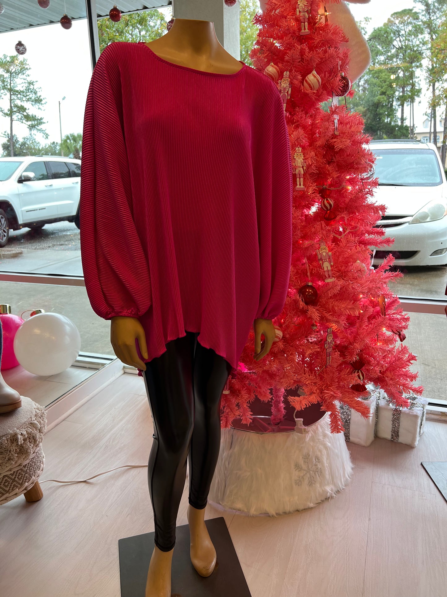 Shiny black leggings paired with pink top