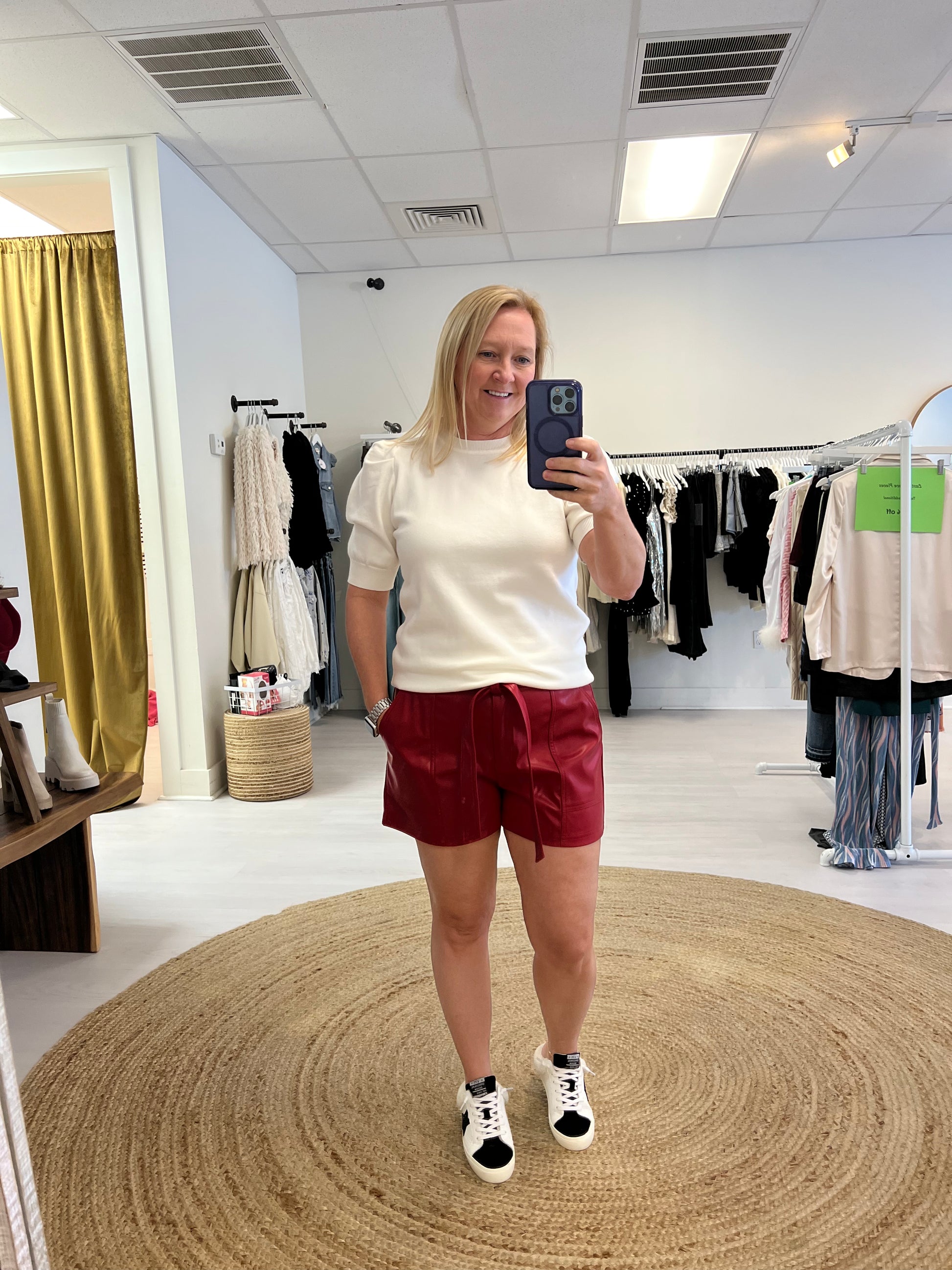 White sweater with red leather shorts
