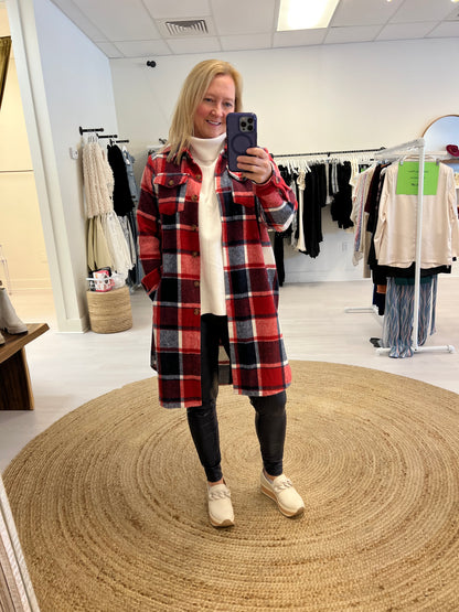 Red plaid flannel shacket with leggings and a sweater