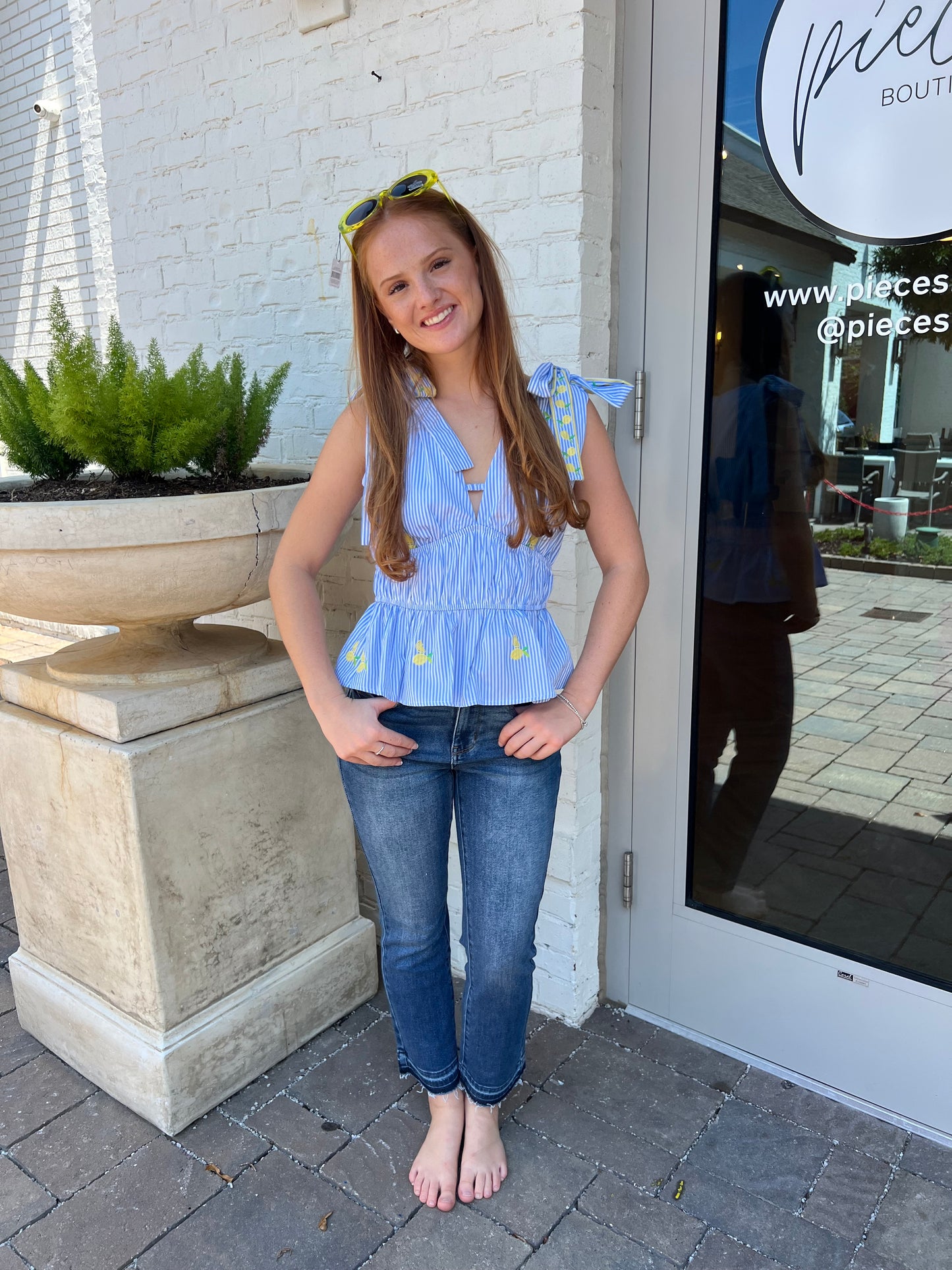 blue striped sleeveless top with embroidered lemons