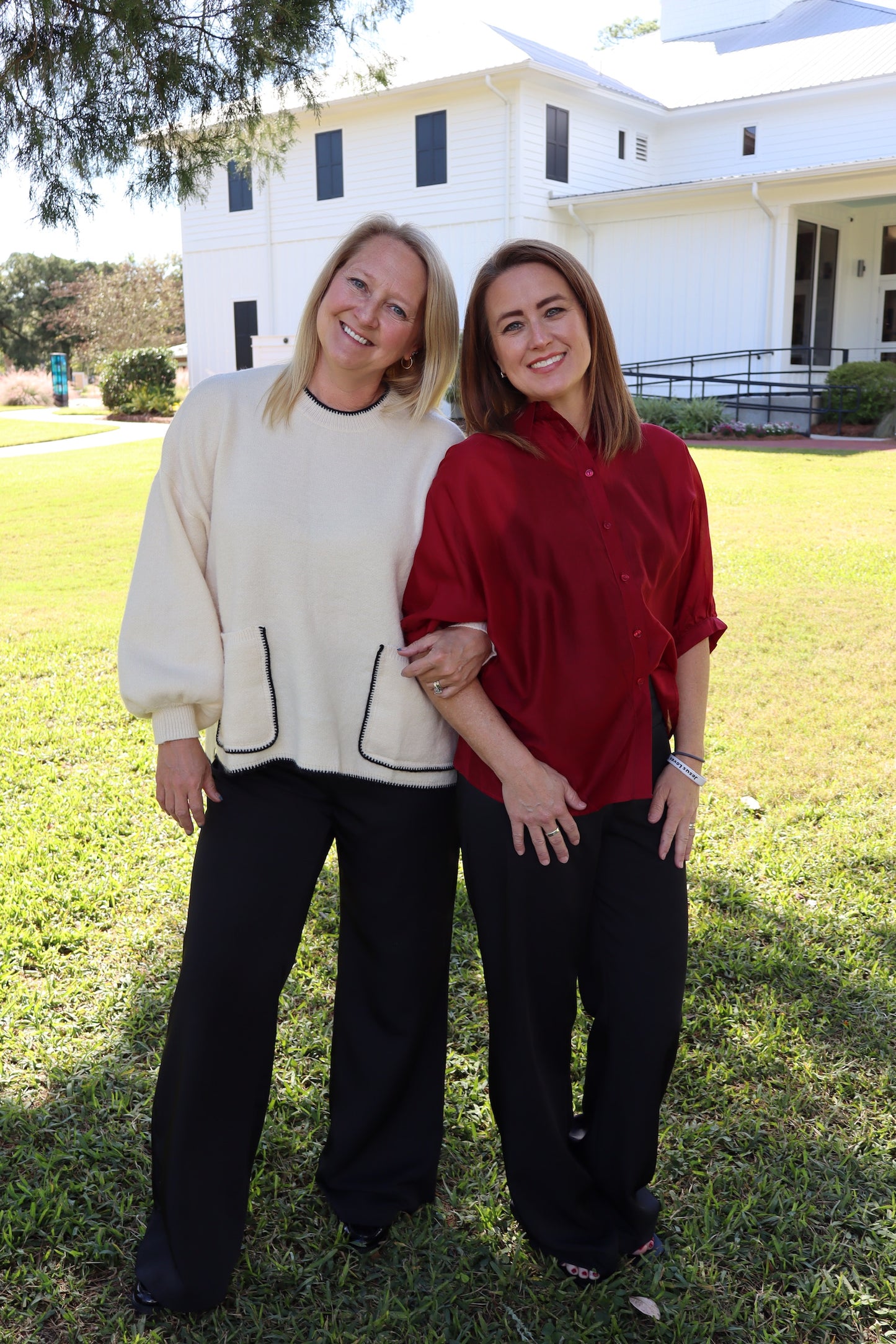 black slacks with cream sweater and maroon top