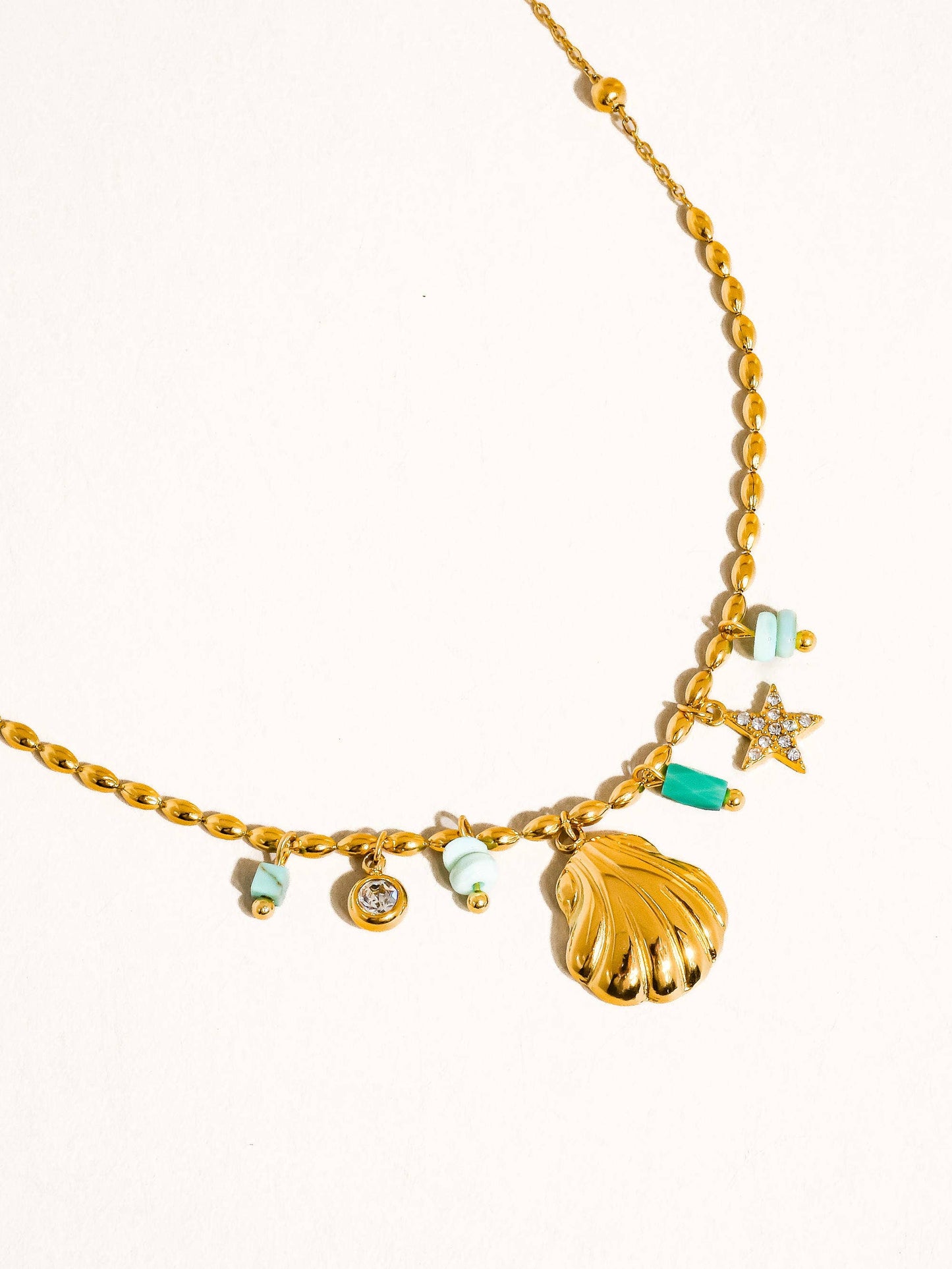 gold necklace with shell charms