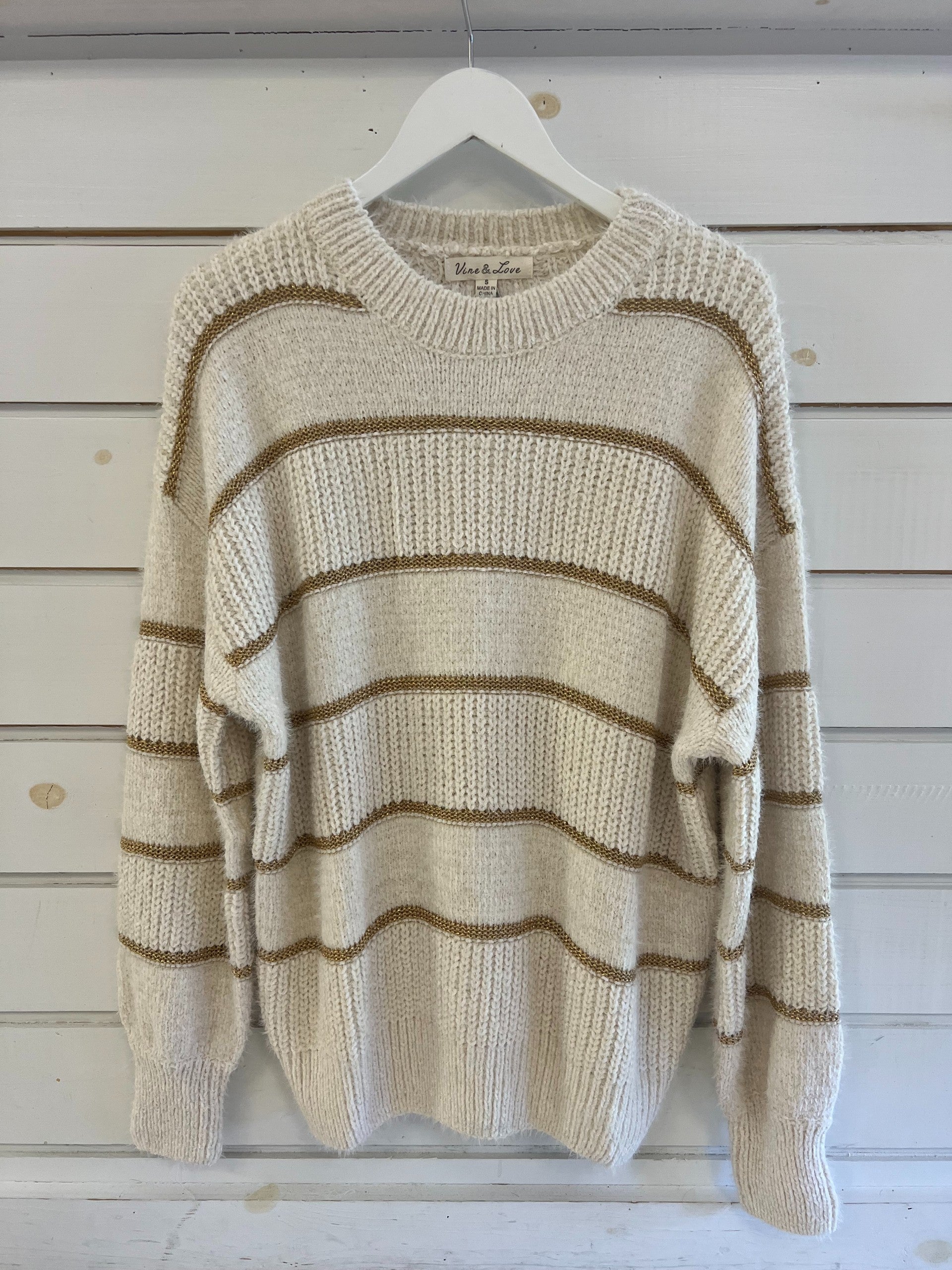 cream sweater with gold stripes